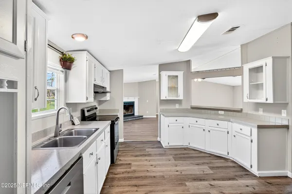 a large kitchen with a sink and cabinets