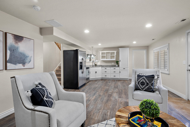 927 Iris Lane Mapleton, UT 84664 - Photo 17 of 31 Open-concept living area with wood-finish flooring, recessed lighting, and a white kitchen with granite countertops