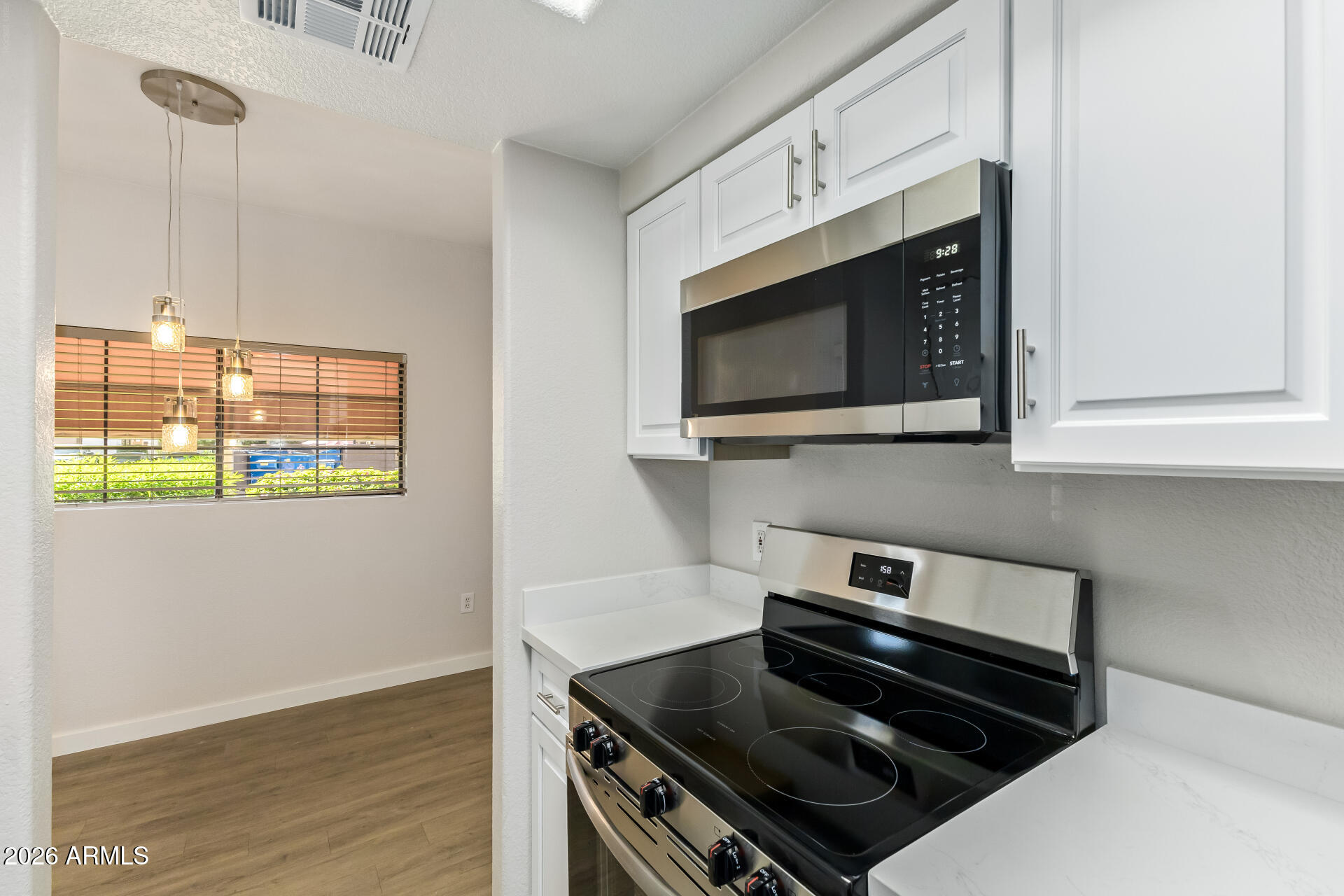 3434 East Baseline Road, Unit 109 Phoenix, AZ 85042 - Photo 11 of 40 a kitchen with stainless steel appliances a stove and a microwave