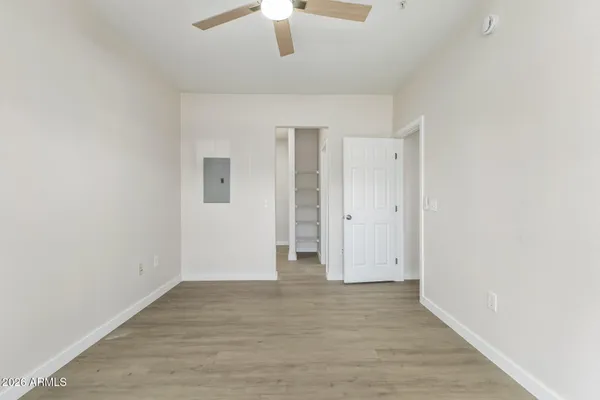 a view of a hallway with wooden floor