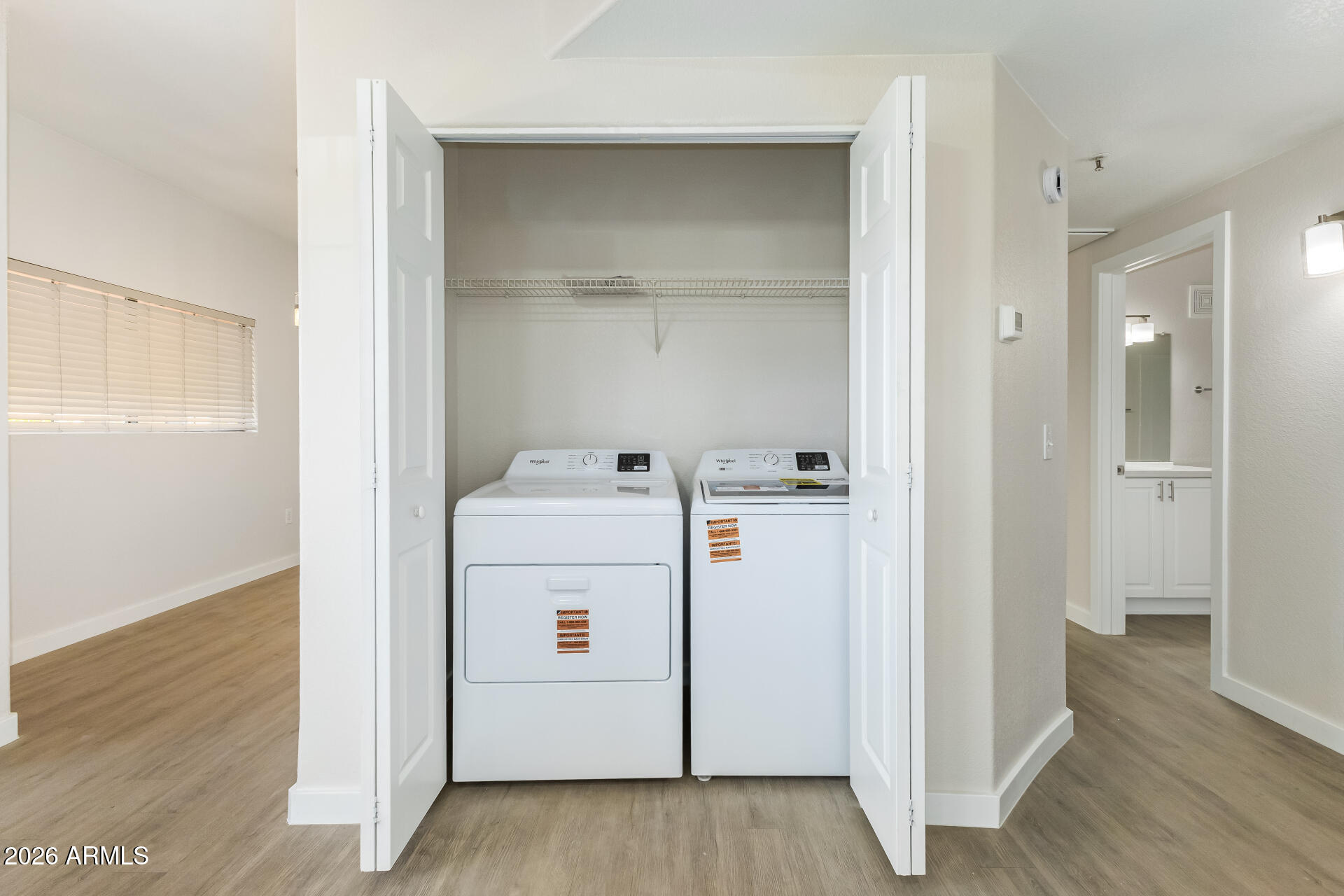 3434 East Baseline Road, Unit 109 Phoenix, AZ 85042 - Photo 26 of 40 a view of washer and dryer with wooden floor