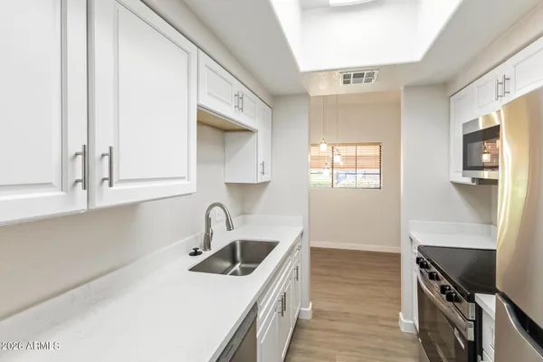 a kitchen with stainless steel appliances a stove and a microwave