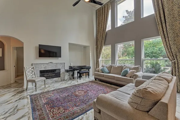 a living room with furniture a fireplace and a flat screen tv