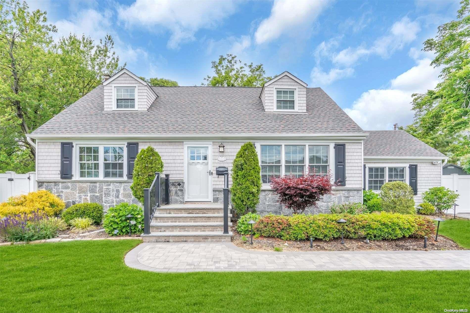 a front view of a house with garden and porch