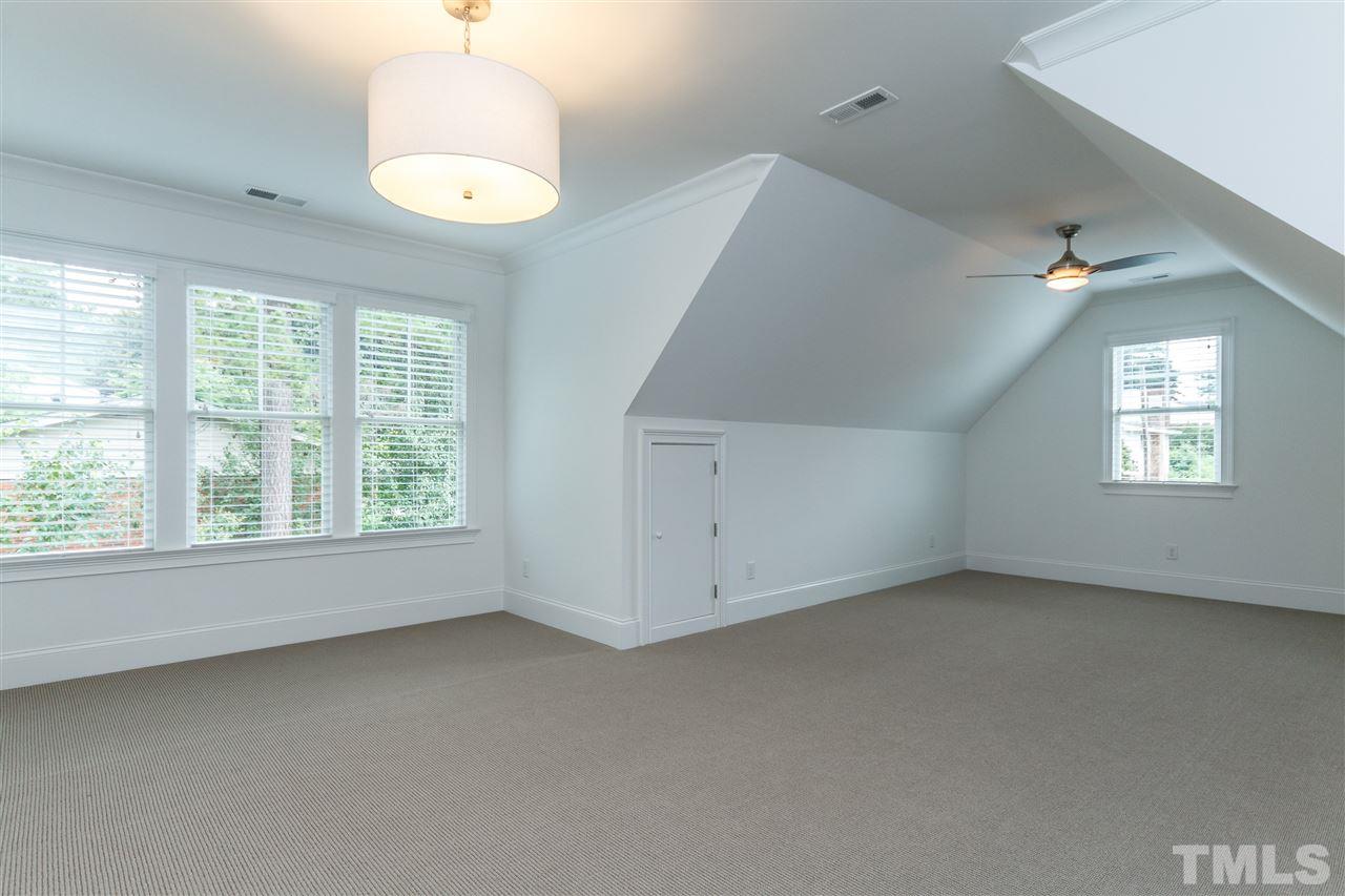 4405 Gates Street Raleigh, NC 27609 - Photo 14 of 18 an empty room with a window and ceiling fan