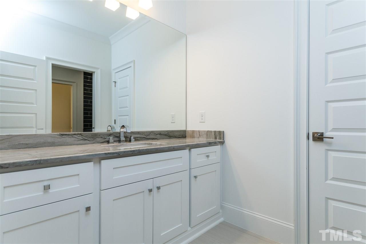 4405 Gates Street Raleigh, NC 27609 - Photo 16 of 18 a bathroom with a granite countertop sink and a mirror