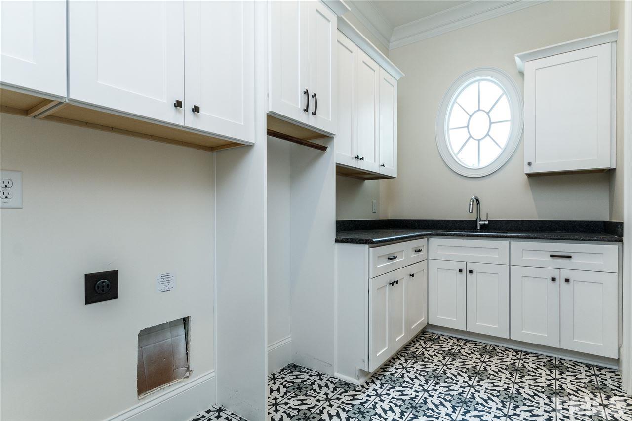 4405 Gates Street Raleigh, NC 27609 - Photo 18 of 18 a kitchen with stainless steel appliances granite countertop a sink a stove and a microwave
