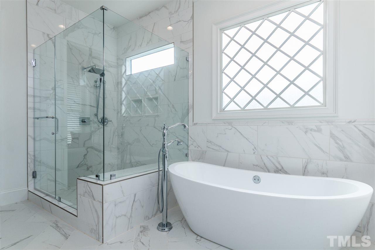4405 Gates Street Raleigh, NC 27609 - Photo 9 of 18 a white bath tub sitting next to a shower