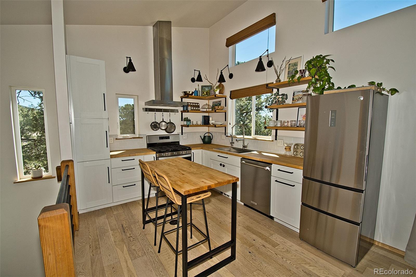 4352 Rarity Way Crestone, CO 81131 - Photo 20 of 49 a kitchen with stainless steel appliances granite countertop a refrigerator and a stove top oven