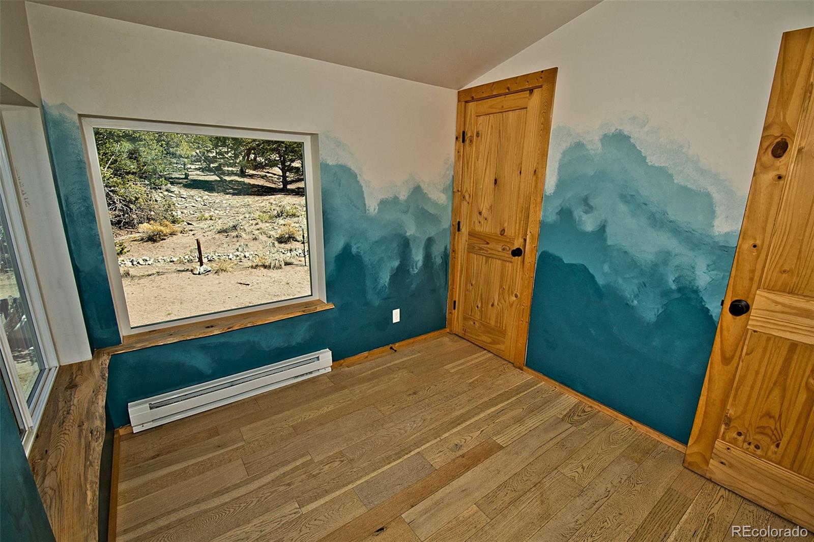 4352 Rarity Way Crestone, CO 81131 - Photo 25 of 49 a bedroom with a bed and a window