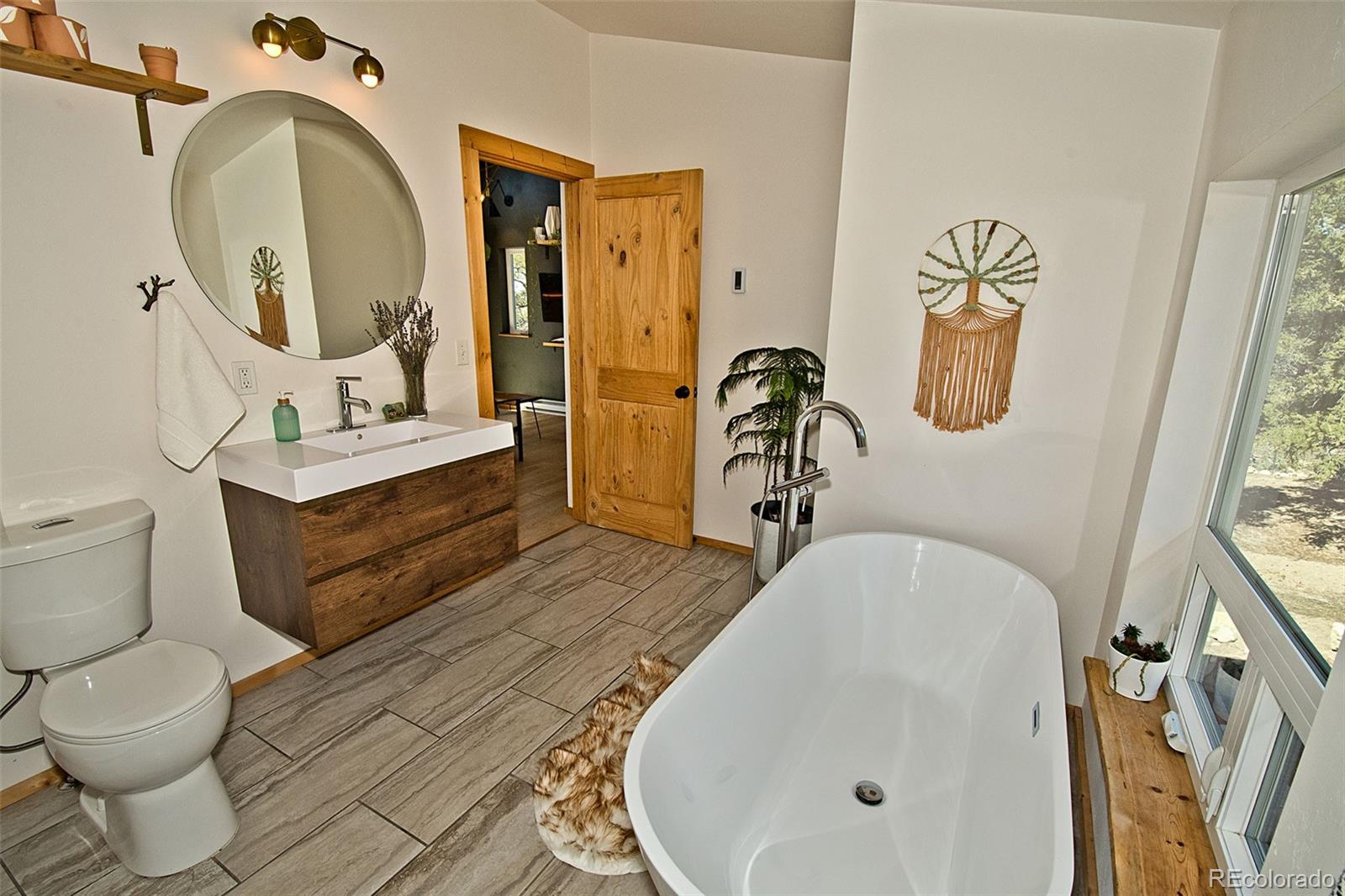 4352 Rarity Way Crestone, CO 81131 - Photo 31 of 49 a bathroom with a sink mirror vanity and toilet