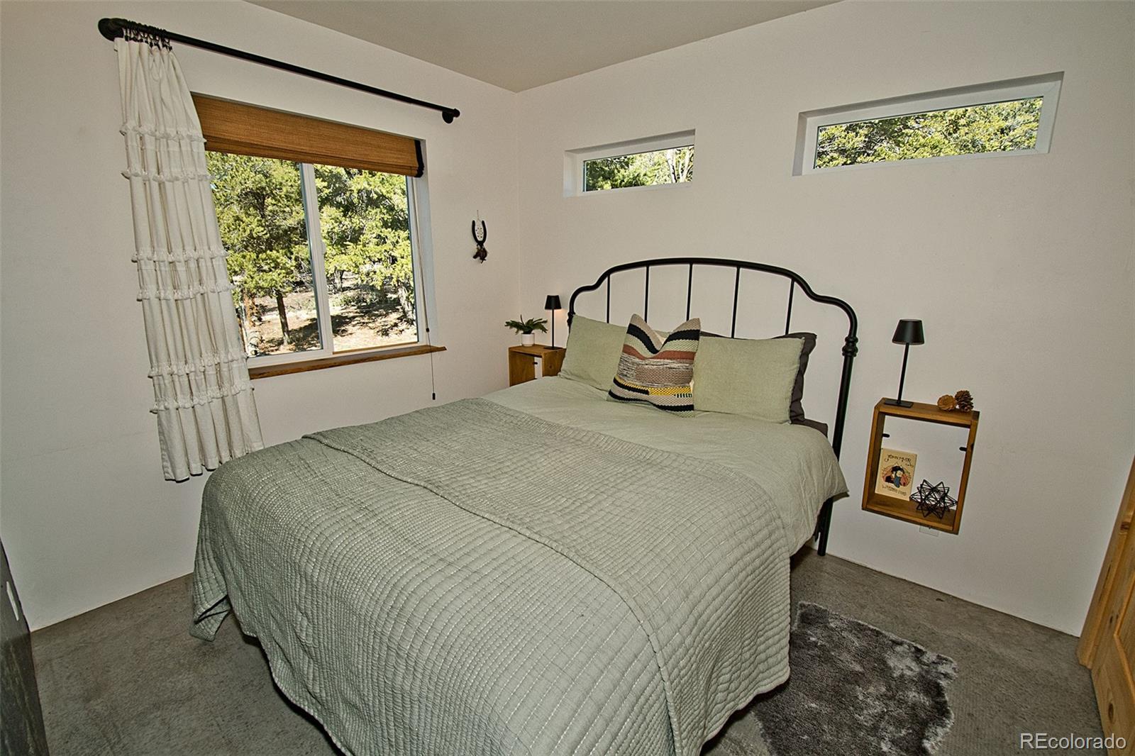 4352 Rarity Way Crestone, CO 81131 - Photo 32 of 49 a large bed sitting in a bedroom next to a window