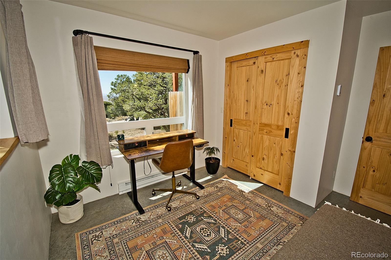 4352 Rarity Way Crestone, CO 81131 - Photo 40 of 49 a view of workspace with wooden floor windows