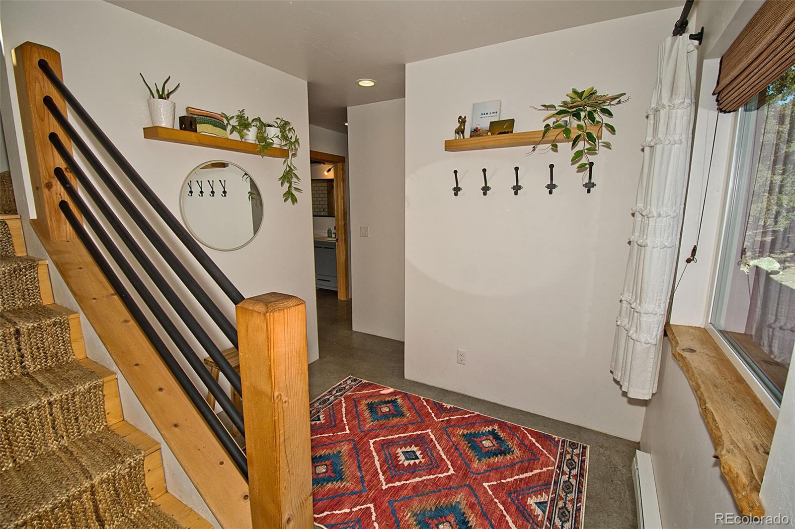 4352 Rarity Way Crestone, CO 81131 - Photo 9 of 49 a hallway with painting on the wall and a large mirror