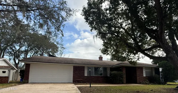 a front view of house with yard and trees