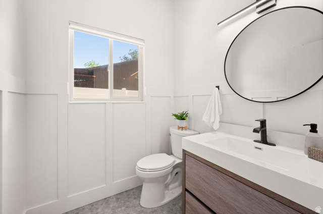 2163 Borg Drive Sandy, UT 84092 - Photo 21 of 31 Half bath with vanity, a decorative wall, and wainscoting