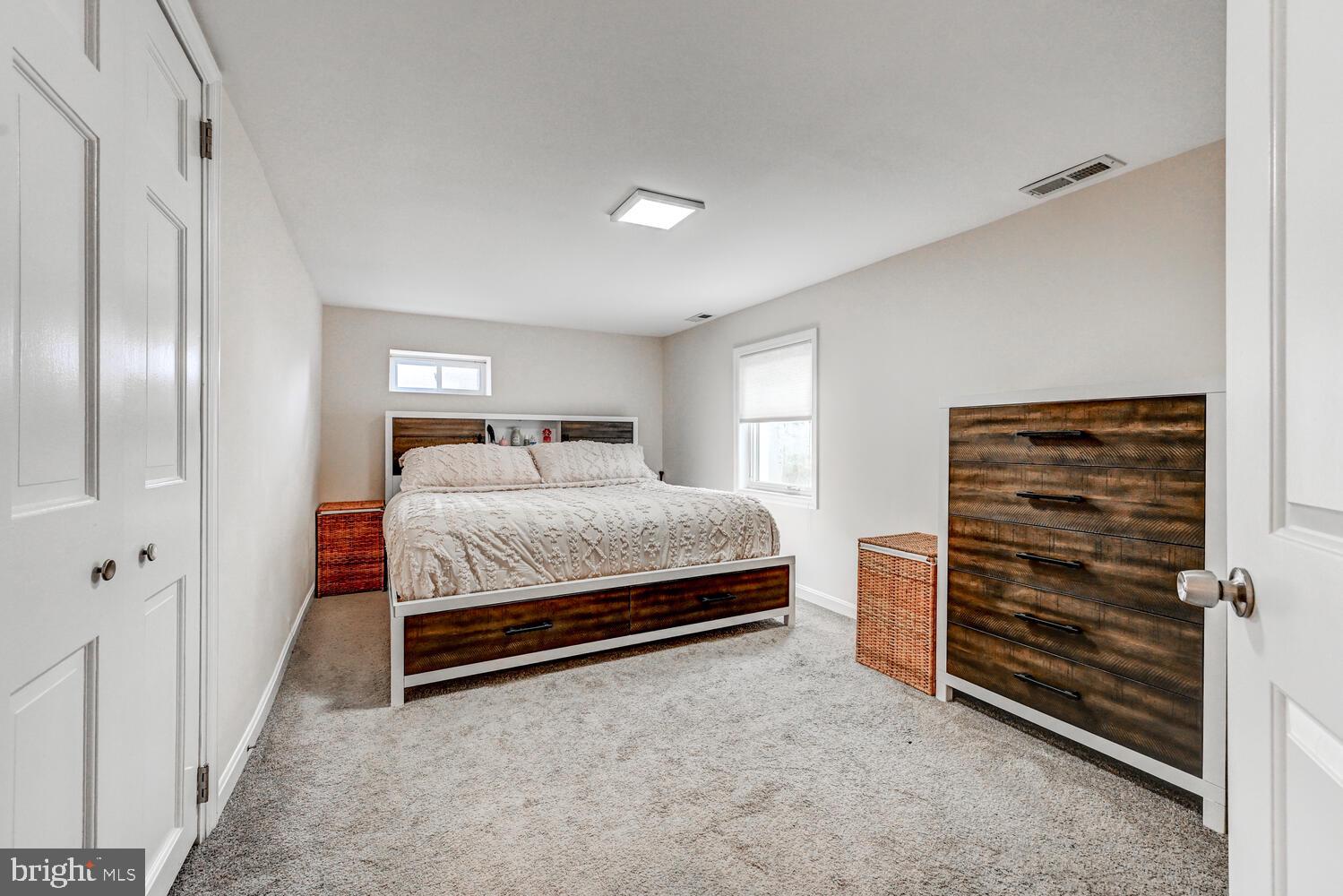 6420 Kenwood Avenue Rosedale, MD 21237 - Photo 17 of 22 a bedroom with a bed and a walk in closet