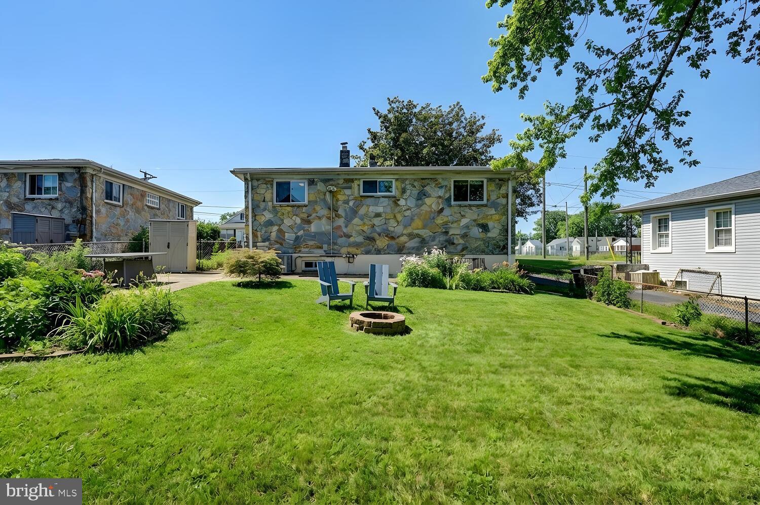 6420 Kenwood Avenue Rosedale, MD 21237 - Photo 22 of 22 a view of a chair and table in backyard of the house