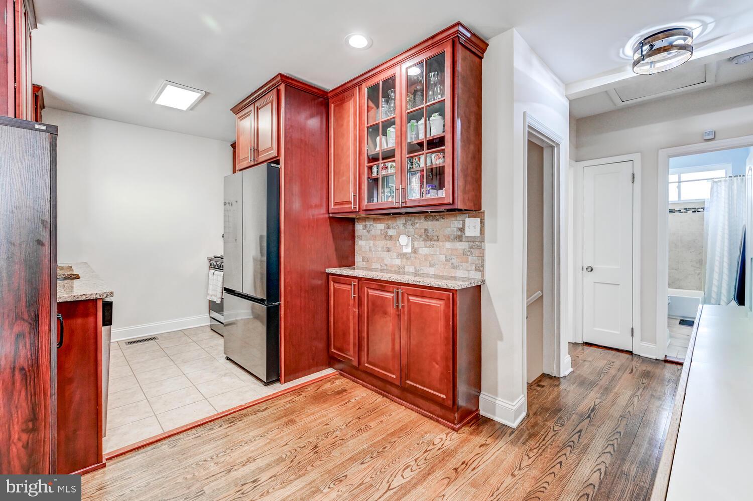 6420 Kenwood Avenue Rosedale, MD 21237 - Photo 7 of 22 a view of front door with hallway and wooden floor