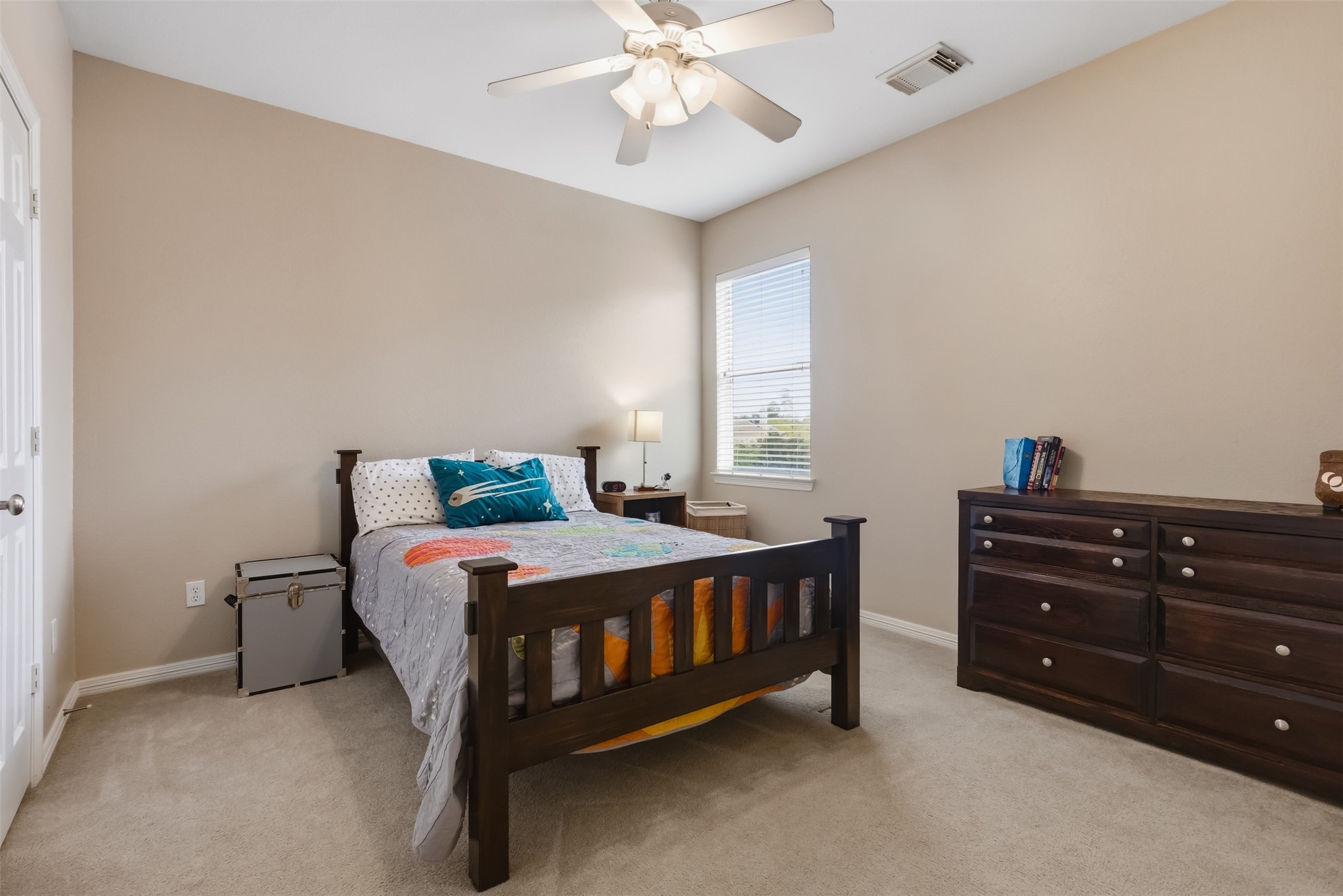 20722 Windrose Bend Drive Spring, TX 77379 - Photo 26 of 50 An inviting upstairs secondary bedroom offers a cozy retreat with high ceilings, soft carpeting, natural light, and a comfortable layout, perfect for relaxation or guests.