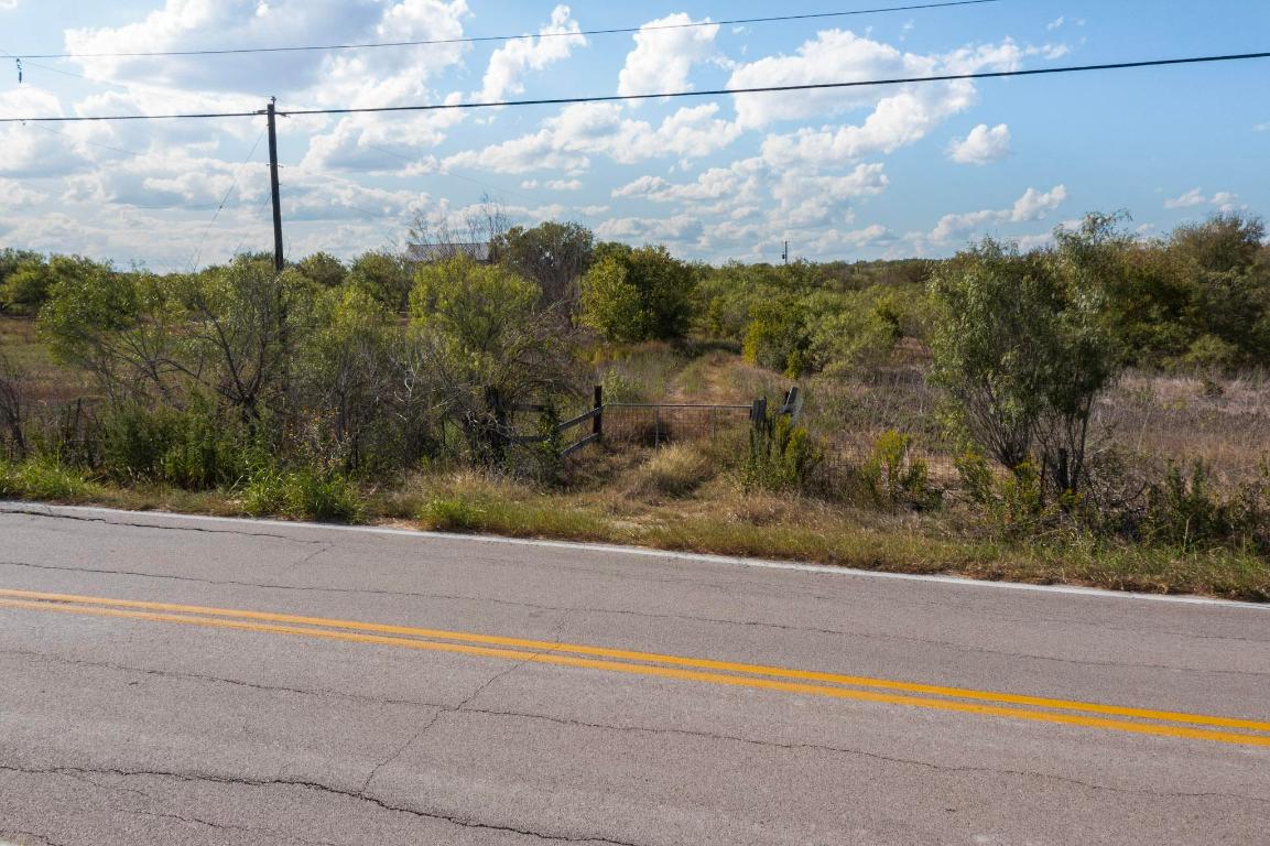 13414 Elm Grove Road Buda, TX 78610 - Photo 13 of 25 a view of a yard next to a road