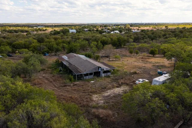 an aerial view of a house with a yard