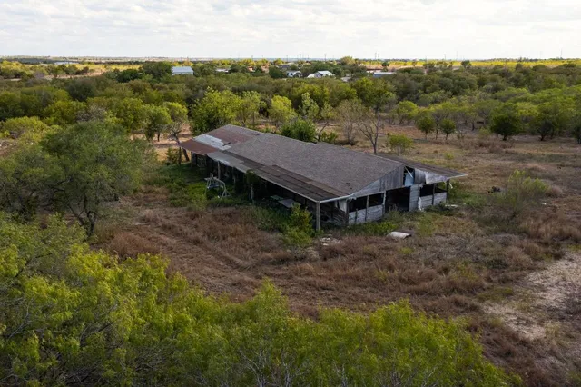 an aerial view of a house with yard and outdoor seating