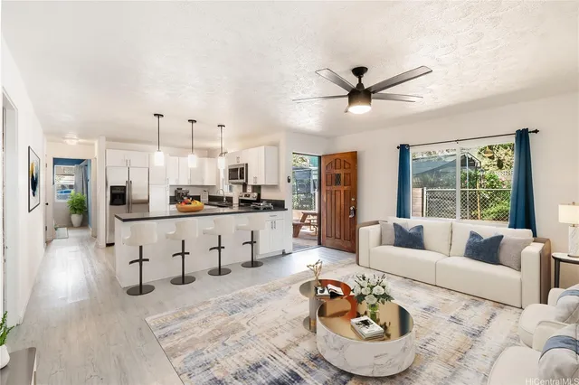 a living room with furniture and kitchen view