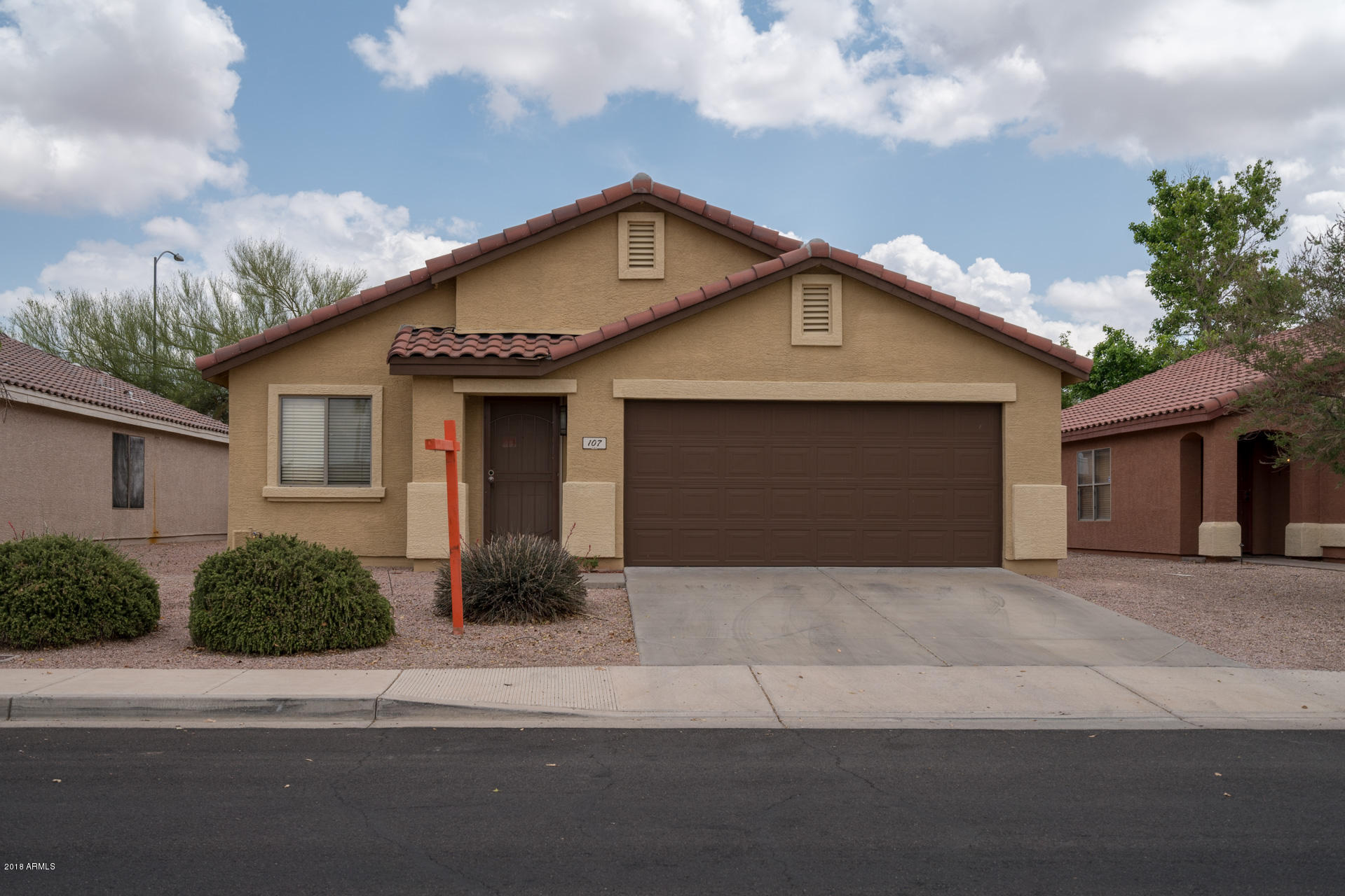 107 South Noble Mesa, AZ 85208 - Photo 1 of 23 a front view of a house with yard and parking