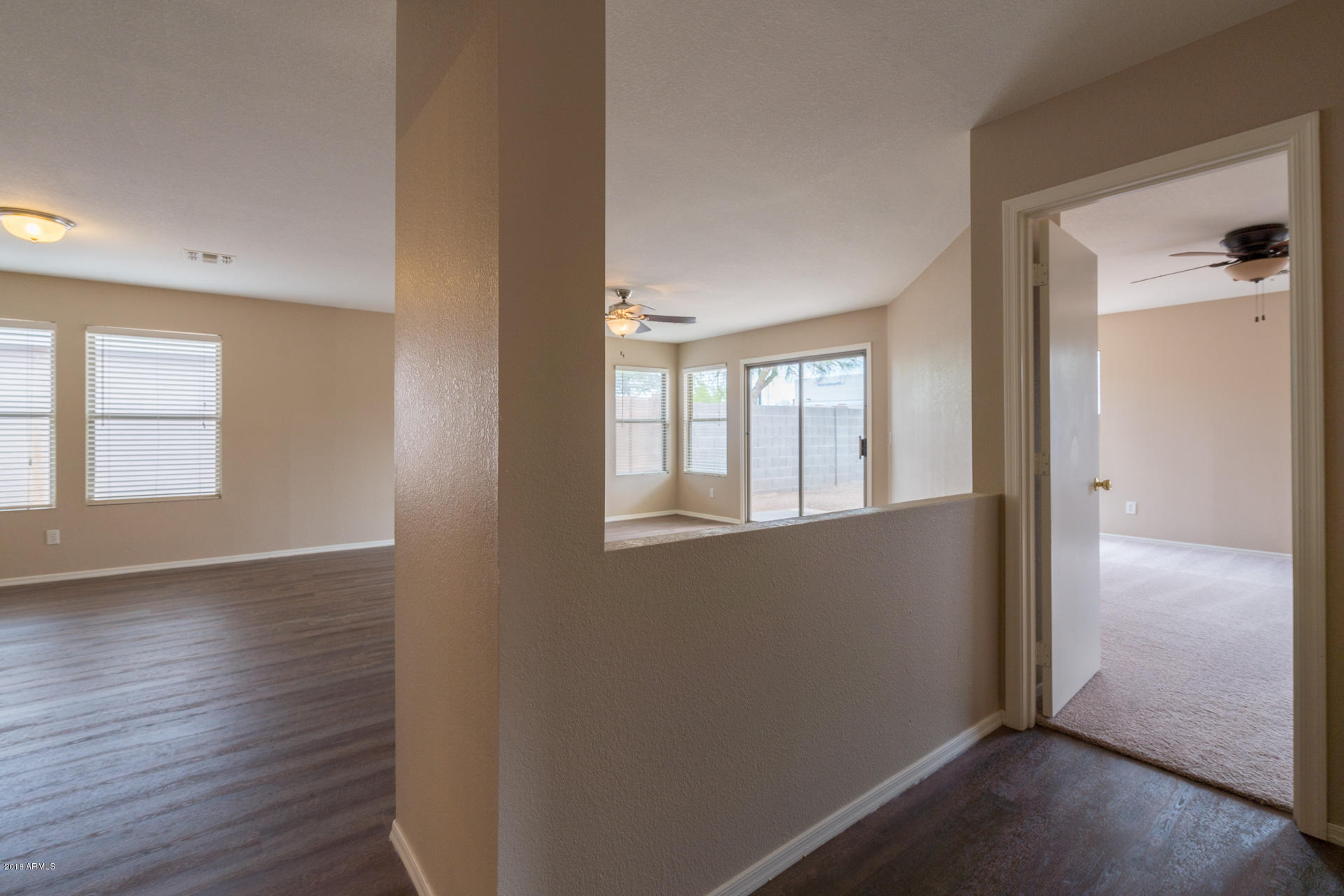 107 South Noble Mesa, AZ 85208 - Photo 11 of 23 an empty room with wooden floor and windows