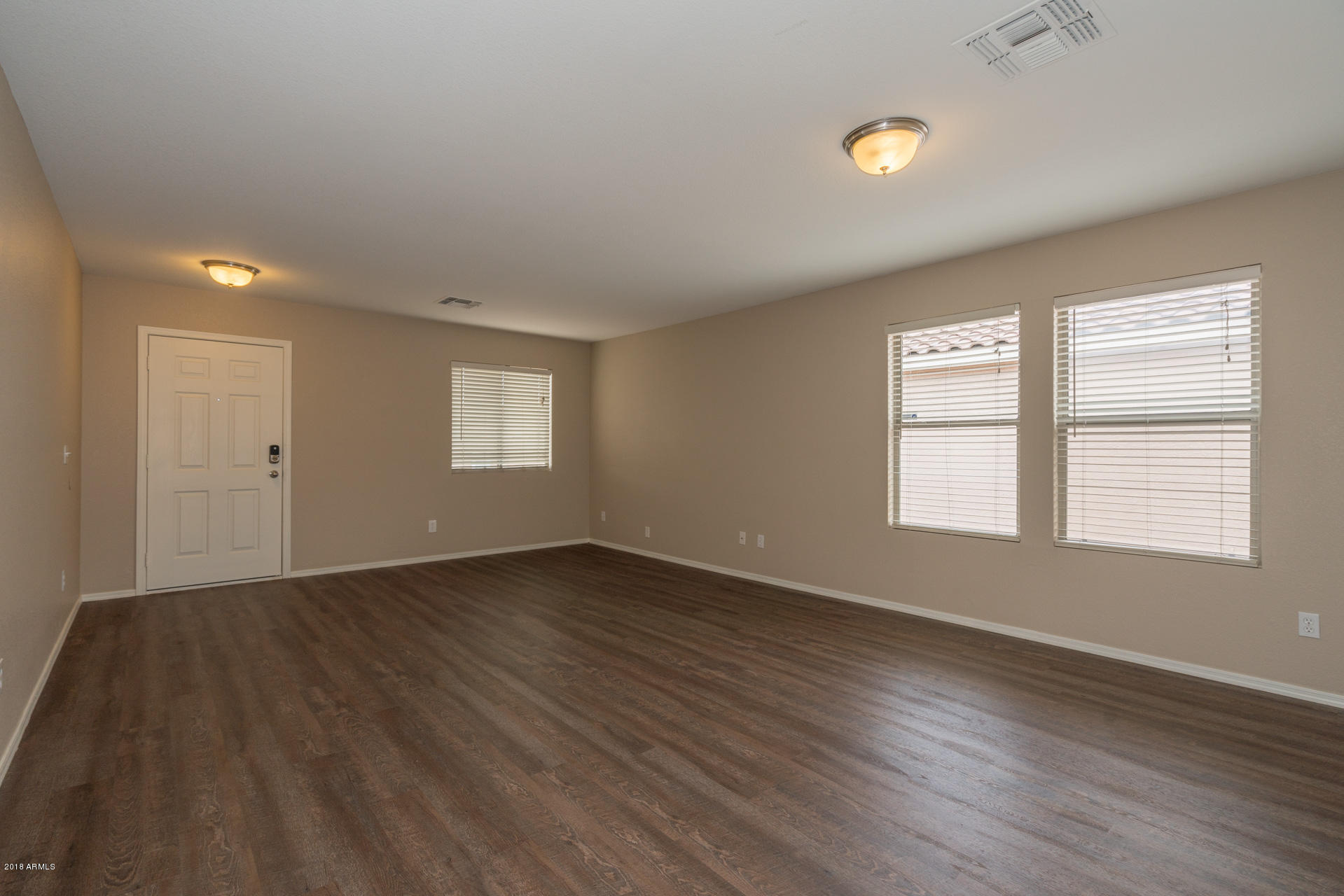 107 South Noble Mesa, AZ 85208 - Photo 2 of 23 an empty room with wooden floor and window