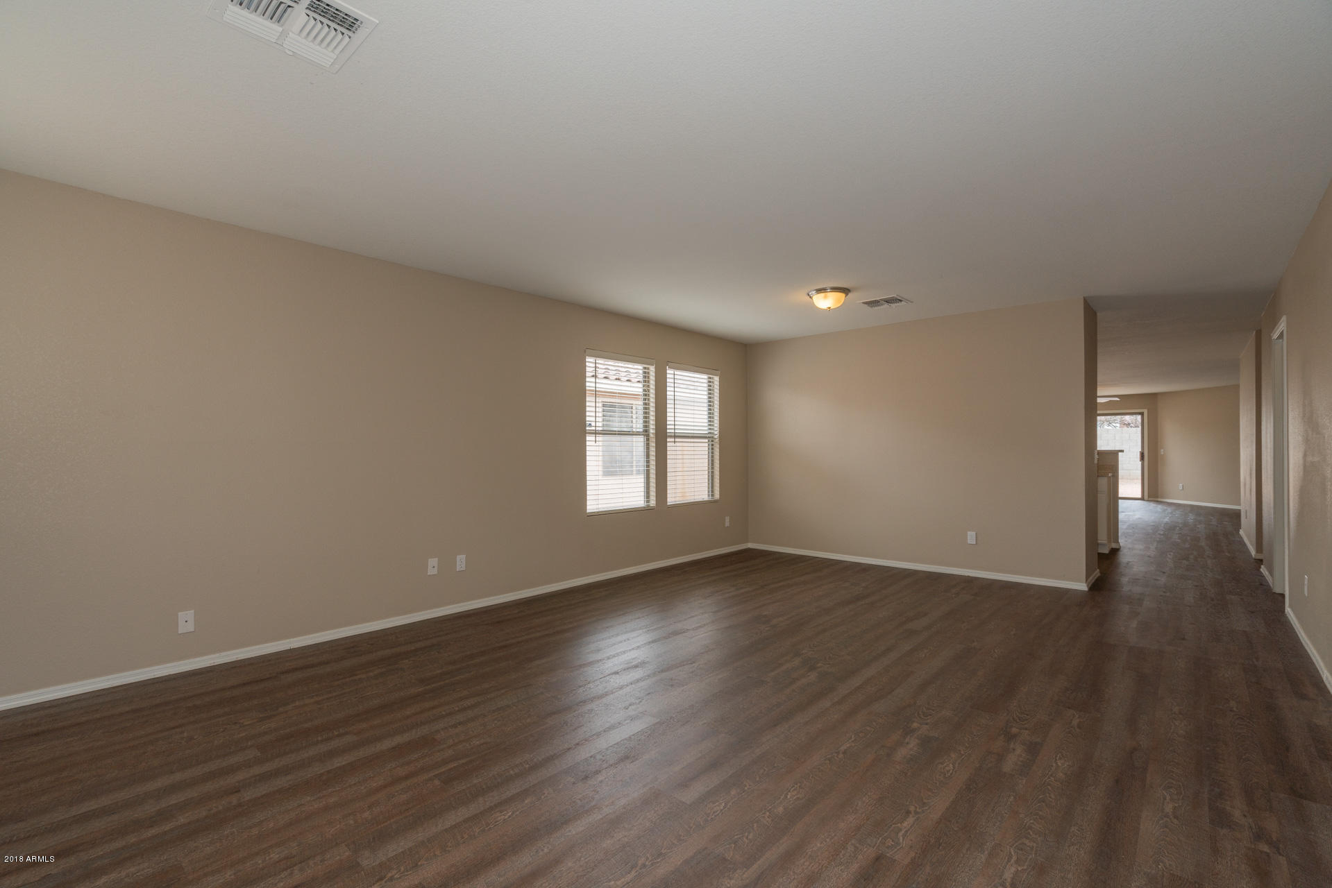 107 South Noble Mesa, AZ 85208 - Photo 3 of 23 a view of an empty room with wooden floor and a window