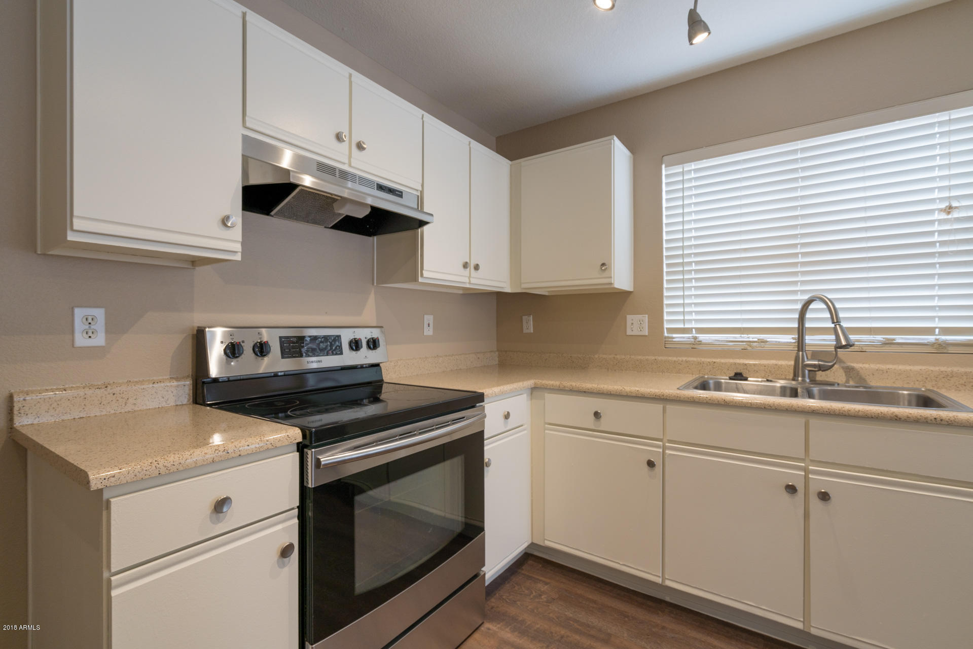 107 South Noble Mesa, AZ 85208 - Photo 7 of 23 a kitchen with cabinets stainless steel appliances and a sink