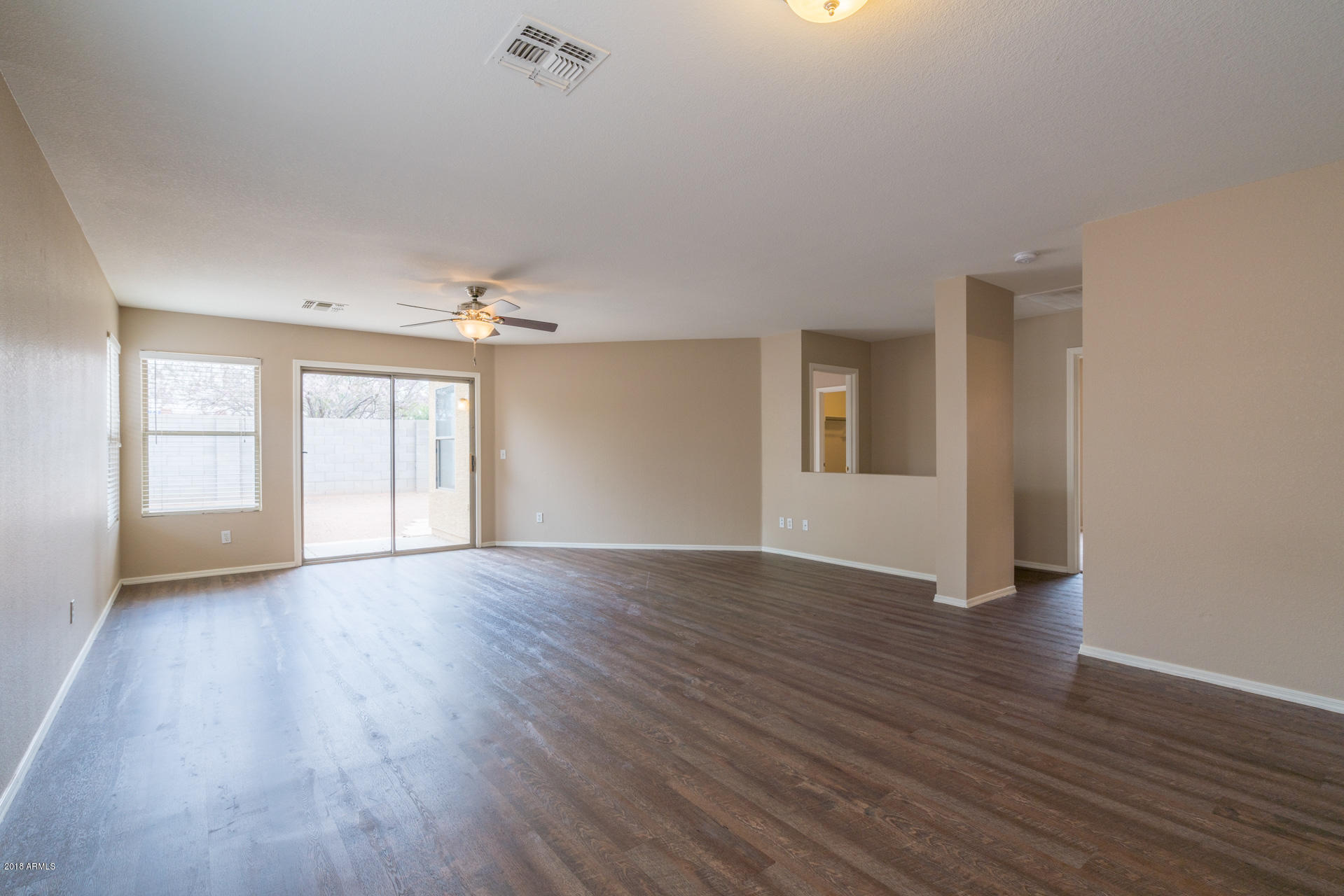 107 South Noble Mesa, AZ 85208 - Photo 9 of 23 a view of an empty room with wooden floor and a window