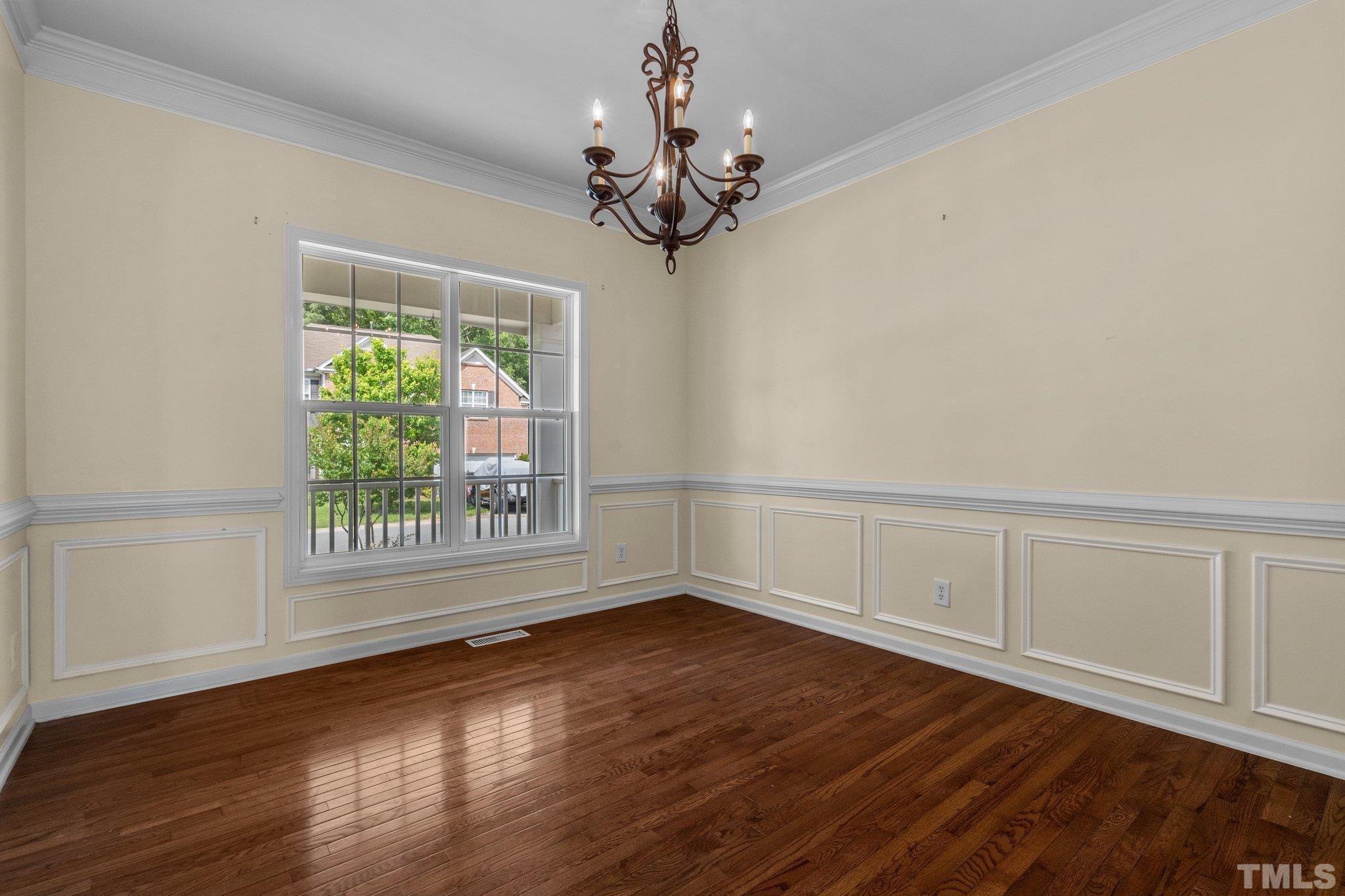 6010 Clarks Fork Drive Raleigh, NC 27616 - Photo 11 of 40 a view of an empty room with wooden floor and a window