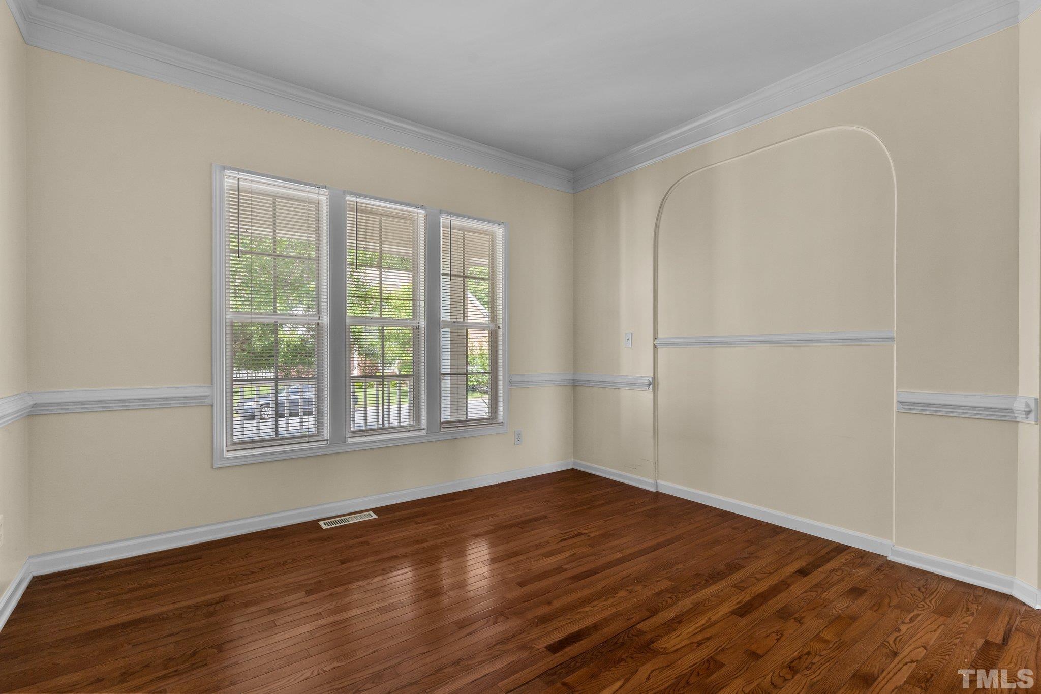 6010 Clarks Fork Drive Raleigh, NC 27616 - Photo 12 of 40 a view of an empty room with wooden floor and a window