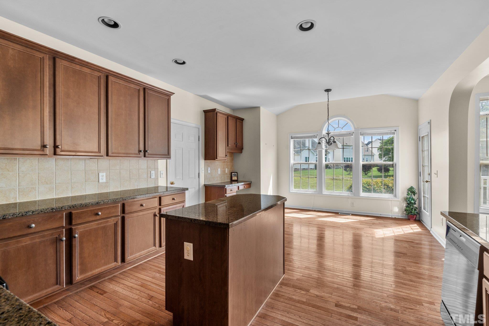 6010 Clarks Fork Drive Raleigh, NC 27616 - Photo 14 of 40 a kitchen with granite countertop a sink and cabinets