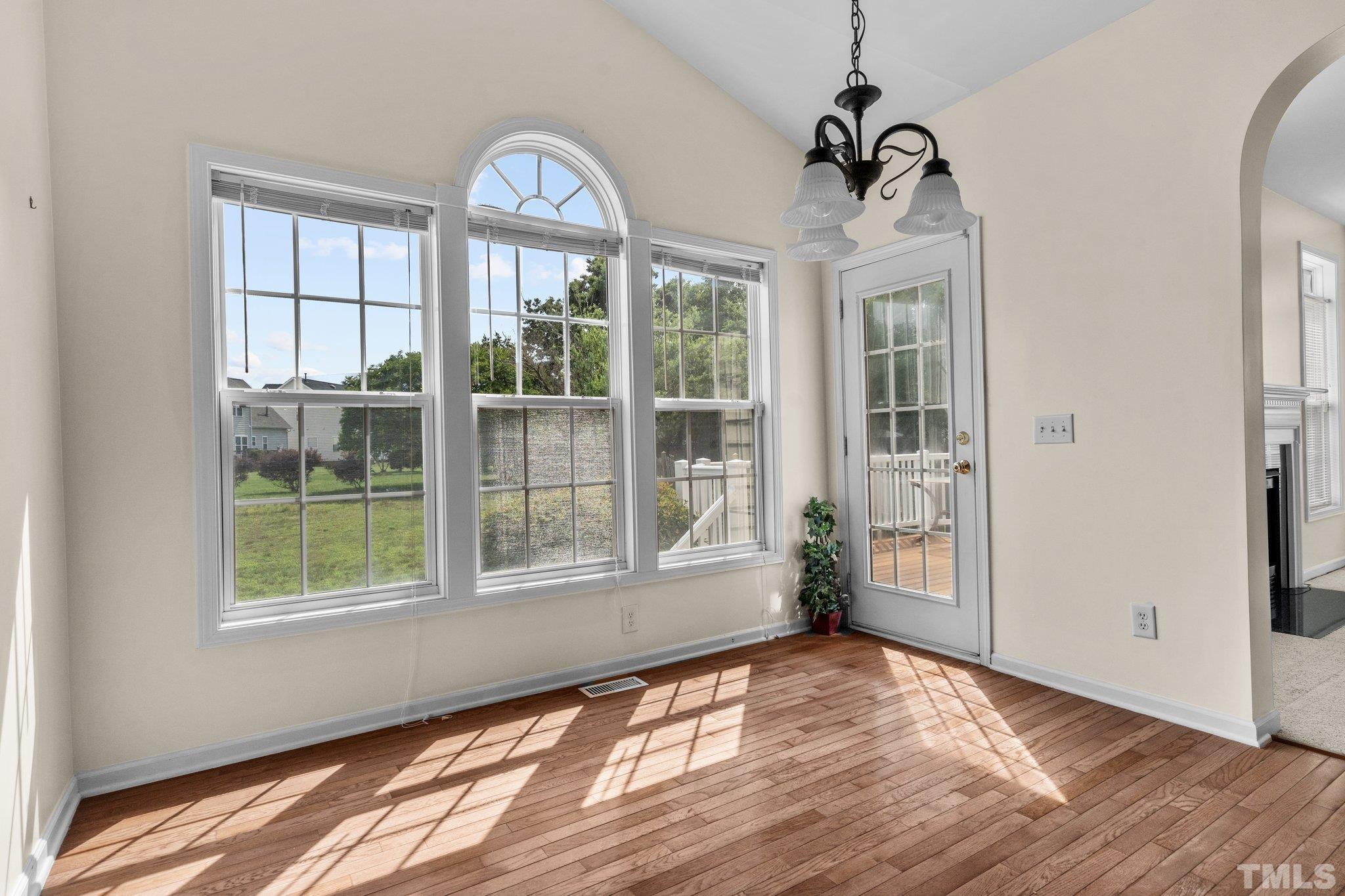 6010 Clarks Fork Drive Raleigh, NC 27616 - Photo 17 of 40 a view of empty room with wooden floor and fan