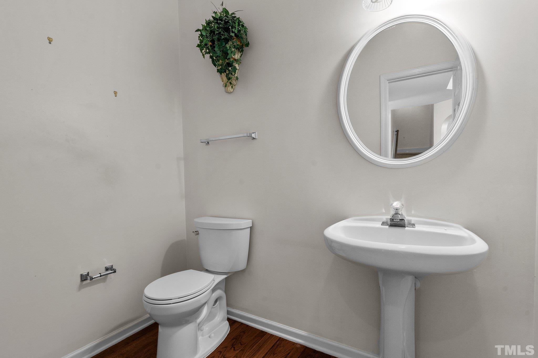 6010 Clarks Fork Drive Raleigh, NC 27616 - Photo 21 of 40 a bathroom with a toilet sink and mirror