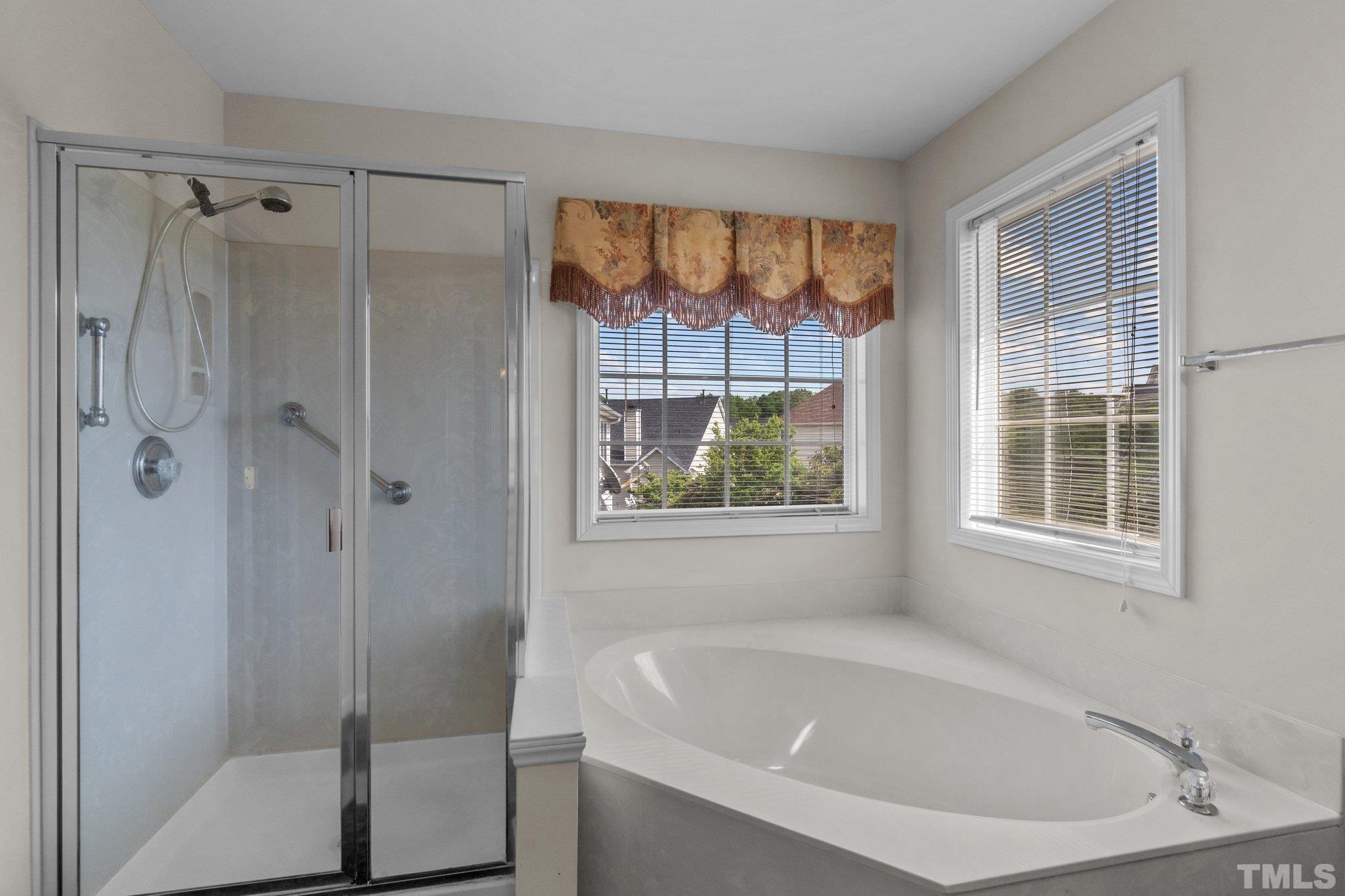 6010 Clarks Fork Drive Raleigh, NC 27616 - Photo 26 of 40 a white bath tub sitting next to a shower