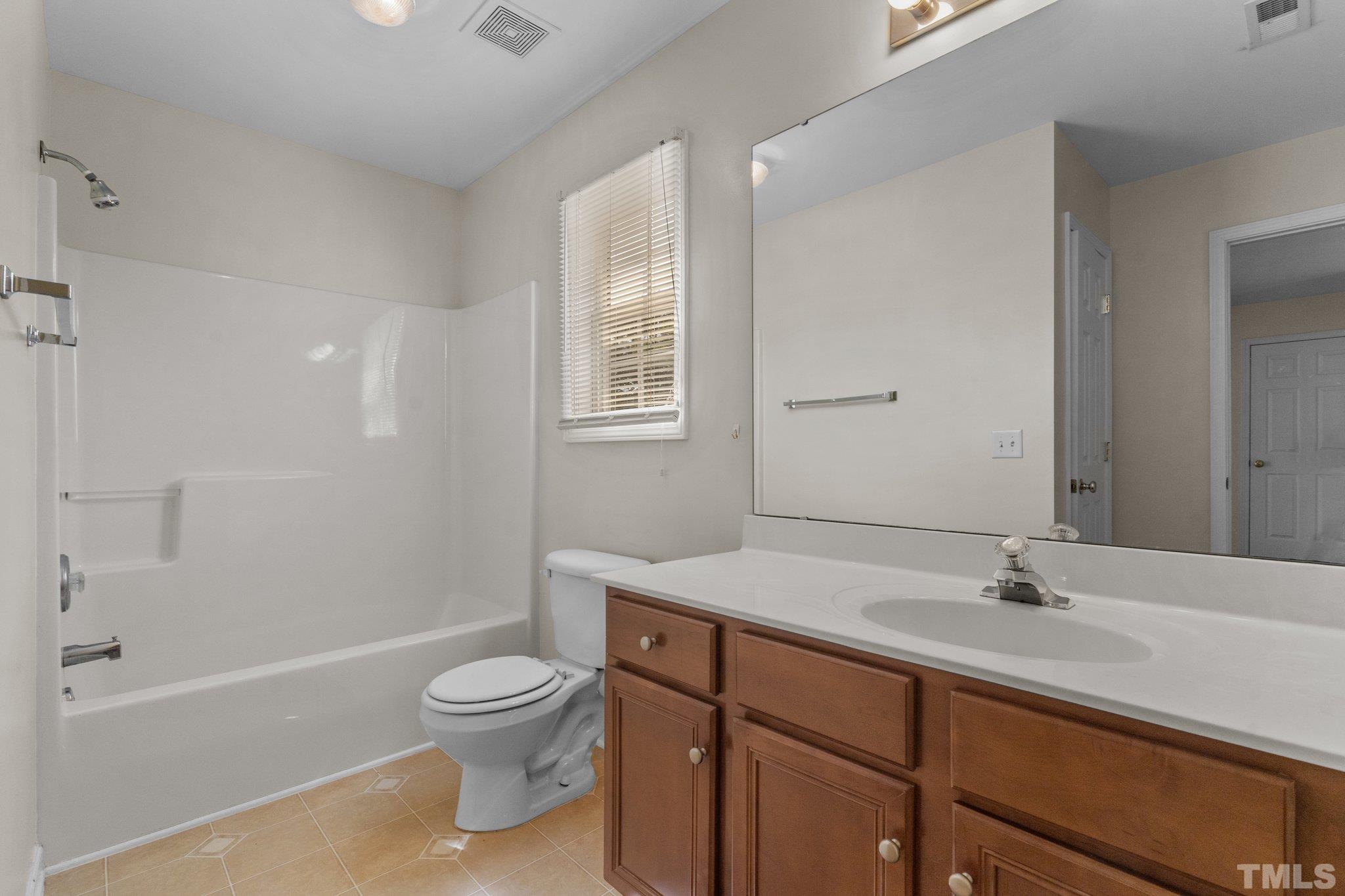 6010 Clarks Fork Drive Raleigh, NC 27616 - Photo 31 of 40 a bathroom with a sink a toilet and a bathtub