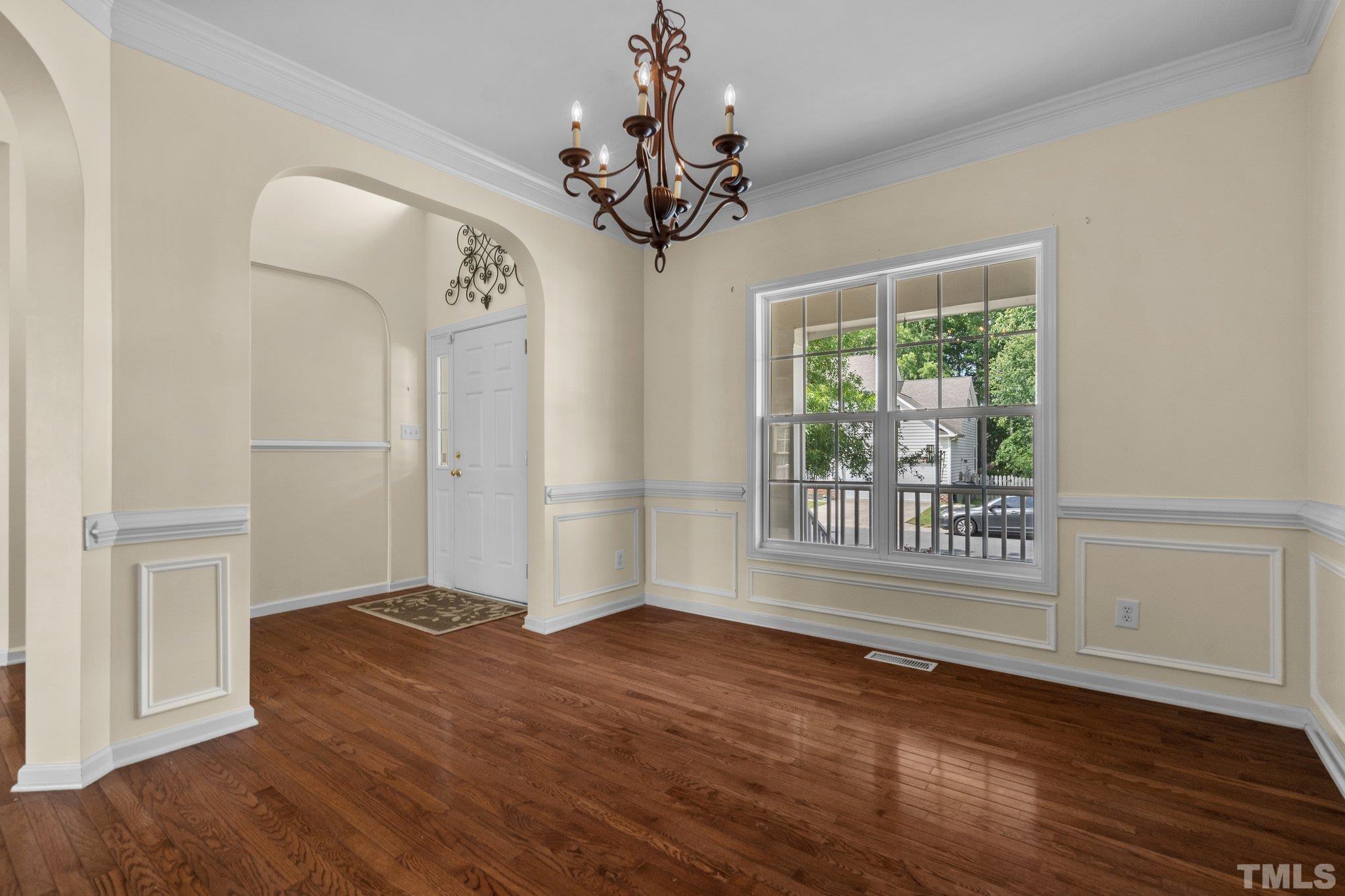 6010 Clarks Fork Drive Raleigh, NC 27616 - Photo 10 of 40 a view of an empty room with wooden floor and a window