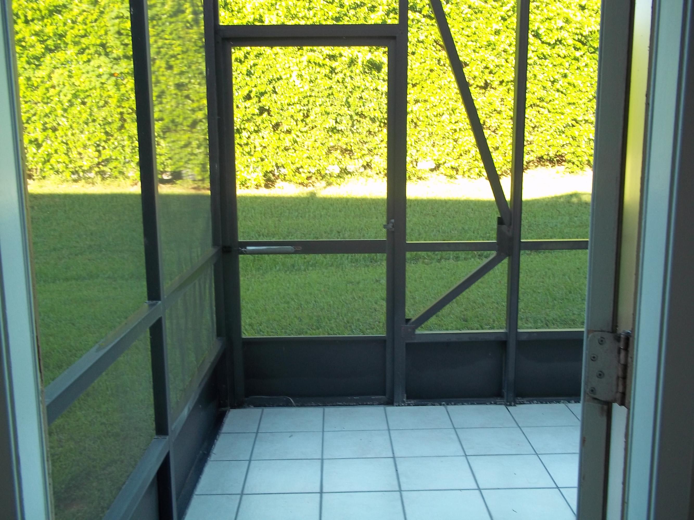 18761 Jolson Avenue, Unit 3 Boca Raton, FL 33496 - Photo 11 of 11 Rear Screen Patio with Tile Floor