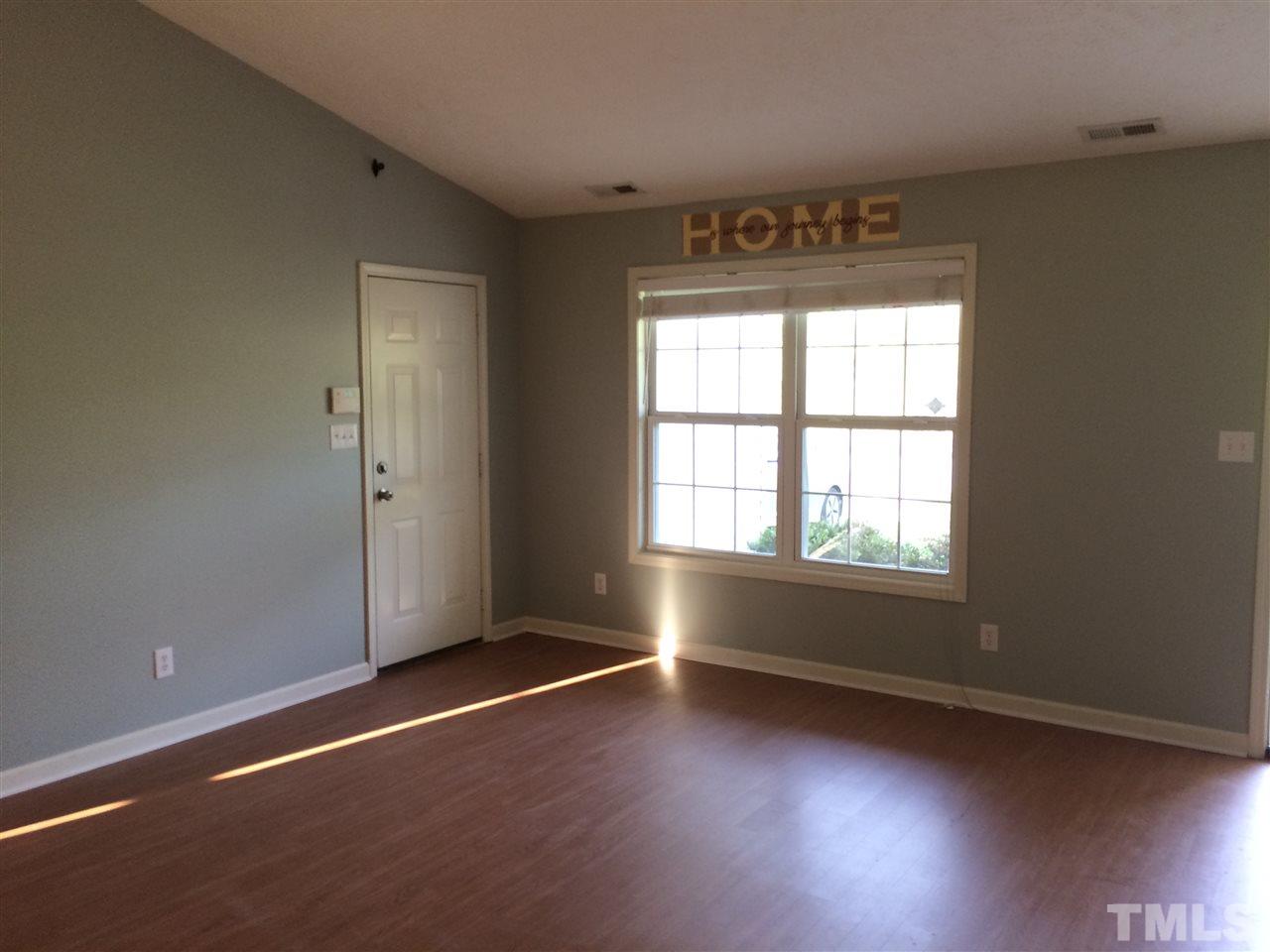 2008 Tingen Road Lillington, NC 27546 - Photo 4 of 25 an empty room with wooden floor and windows