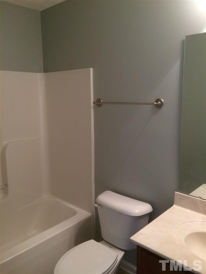 2008 Tingen Road Lillington, NC 27546 - Photo 10 of 25 a white toilet sitting next to a bath tub