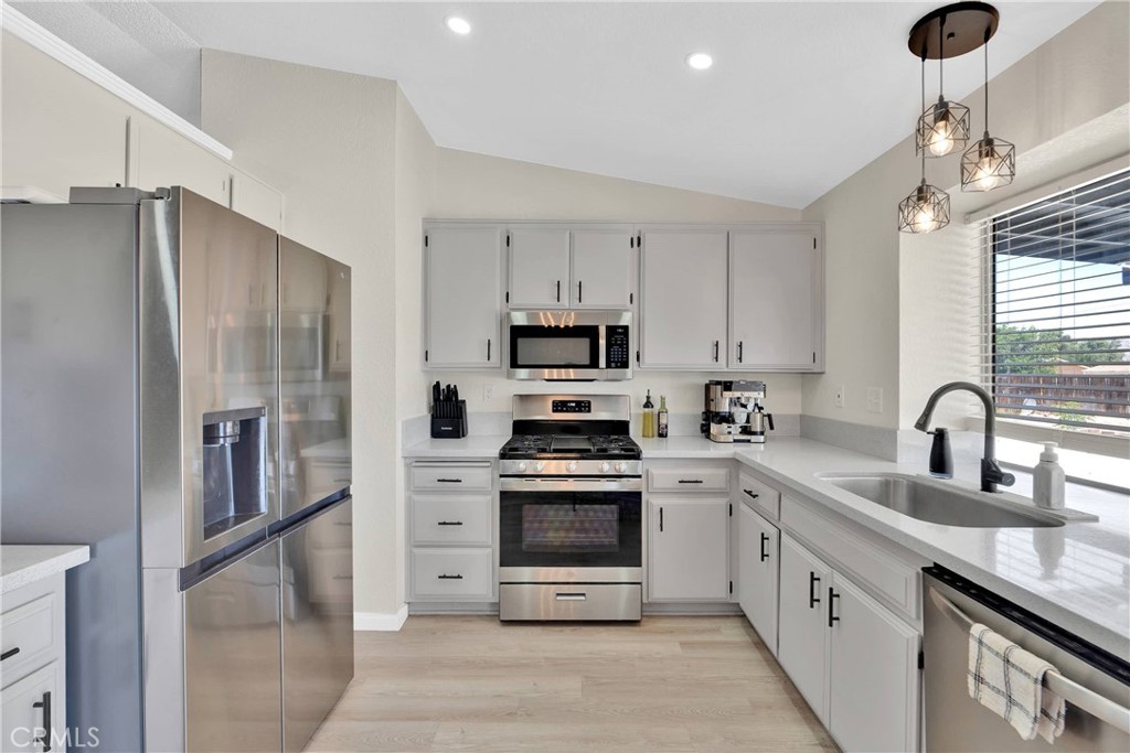 14769 Nanticoke Road Apple Valley, CA 92307 - Photo 12 of 30 a kitchen with stainless steel appliances granite countertop a stove a sink and a refrigerator