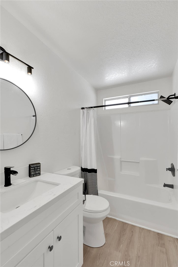 14769 Nanticoke Road Apple Valley, CA 92307 - Photo 14 of 30 a bathroom with a sink a toilet and a mirror
