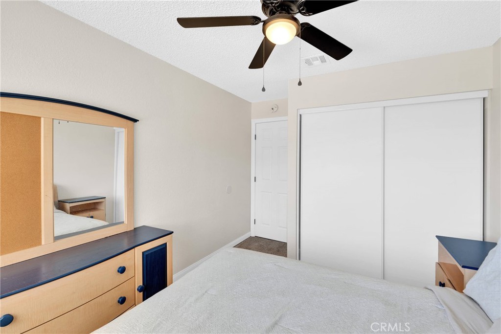 14769 Nanticoke Road Apple Valley, CA 92307 - Photo 15 of 30 a bedroom with a bed and a window