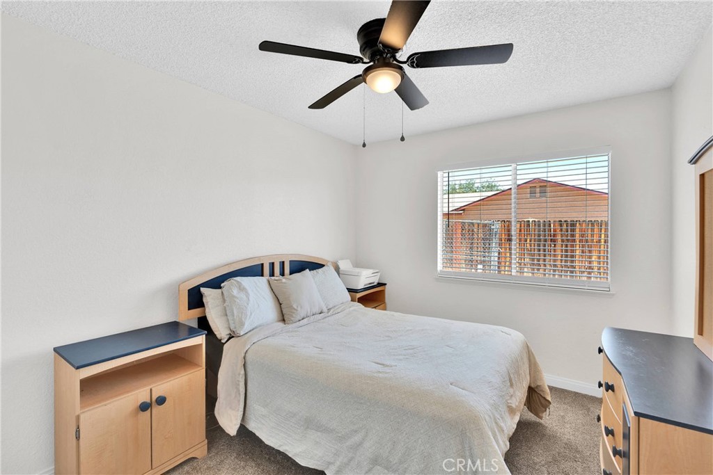 14769 Nanticoke Road Apple Valley, CA 92307 - Photo 16 of 30 a bedroom with a bed and a window