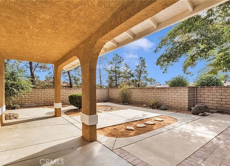 14769 Nanticoke Road Apple Valley, CA 92307 - Photo 2 of 30 a view of backyard with large trees and wooden fence